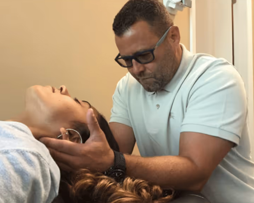Dr. Mark Goldstein performing a precise chiropractic adjustment on a patient